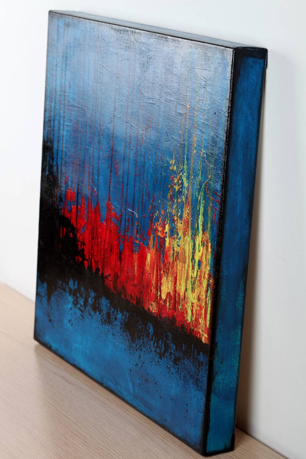 Contemporary abstract artwork in blue, red,black, yelow on stretched canvas