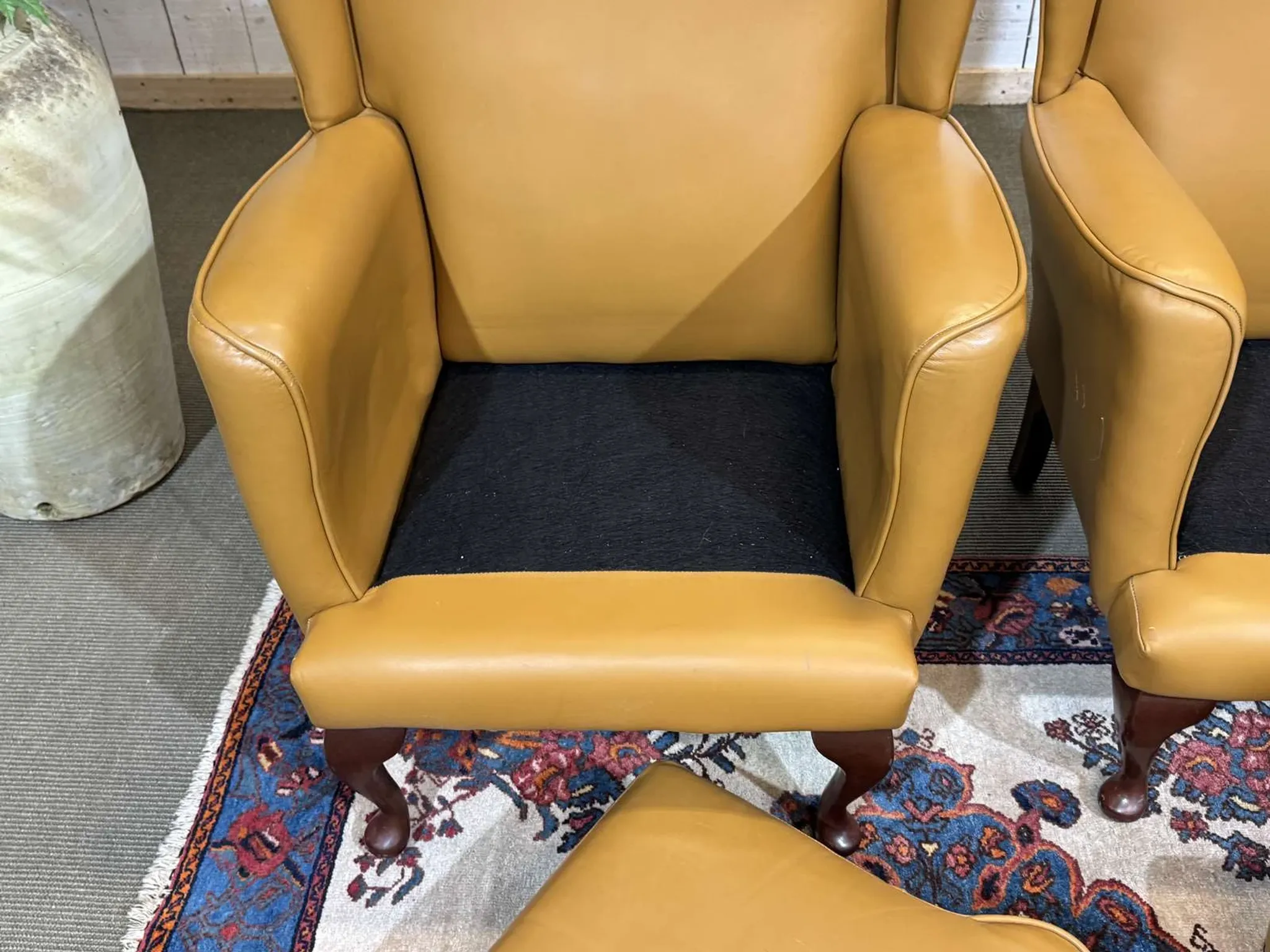 Pair of 1980s English wingback armchairs in leather.