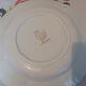 Six white hollow plates on board yellow Monaco 60