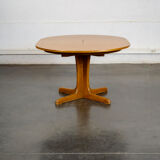 Round teak table with an extension.