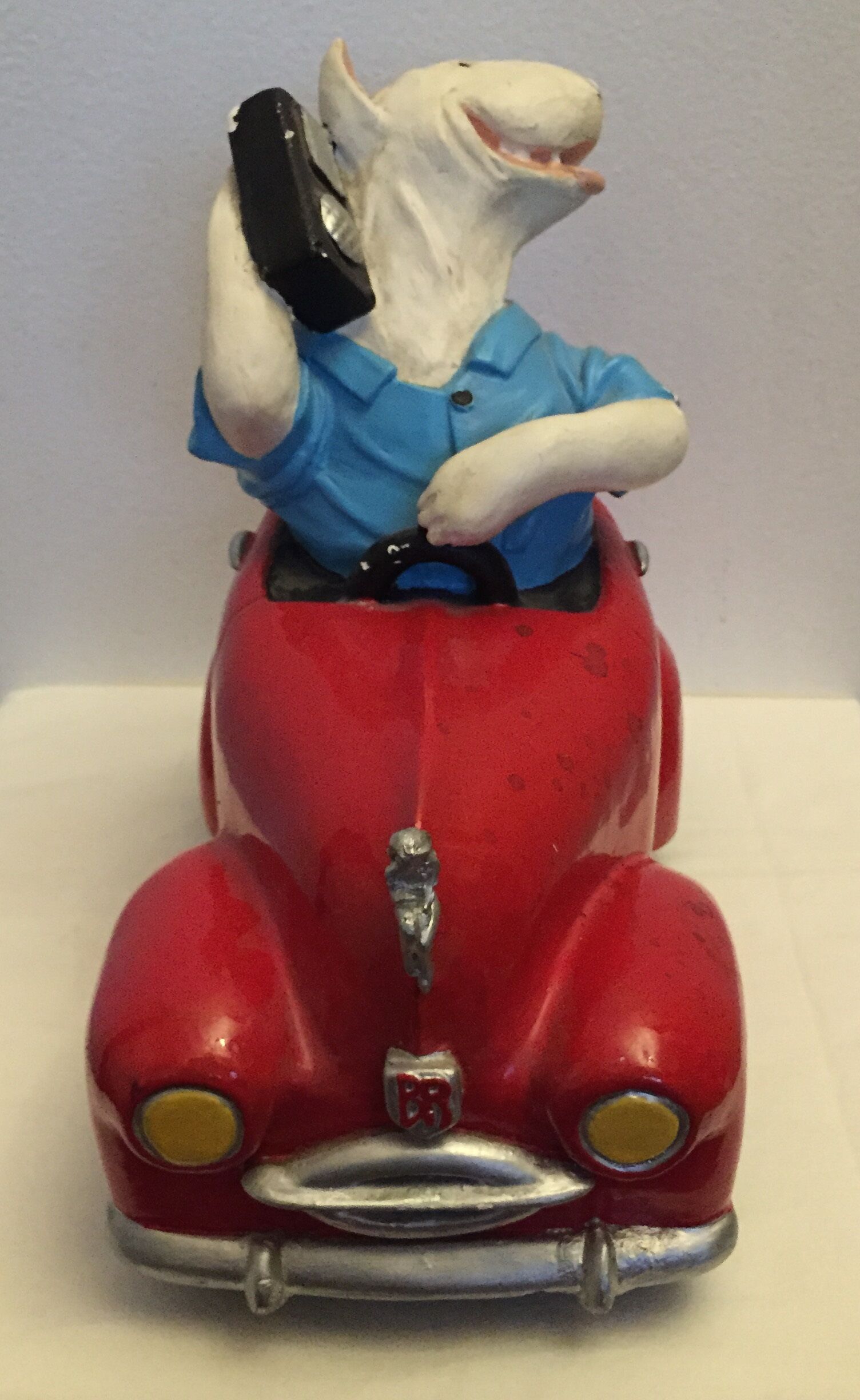 Dog toy driving his red car