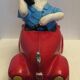 Dog toy driving his red car
