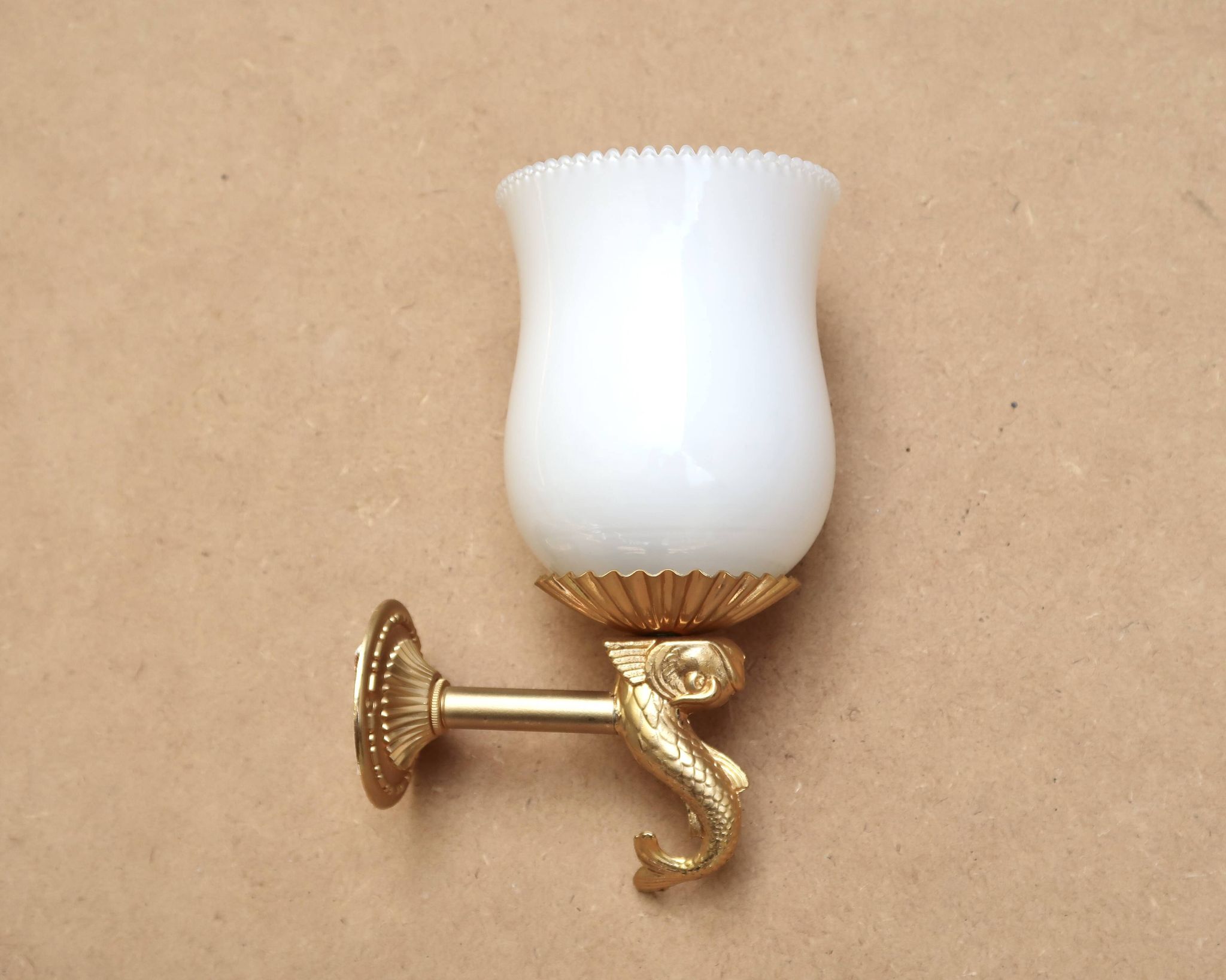 Pair of gold metal and opaque glass wall lights adorned with fish from the 1950s.