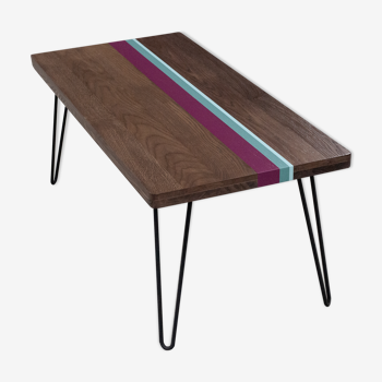 Solid oak coffee table with colored bands on pin legs