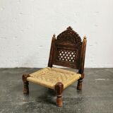 Ancient ethnic chair made of solid wood and rope