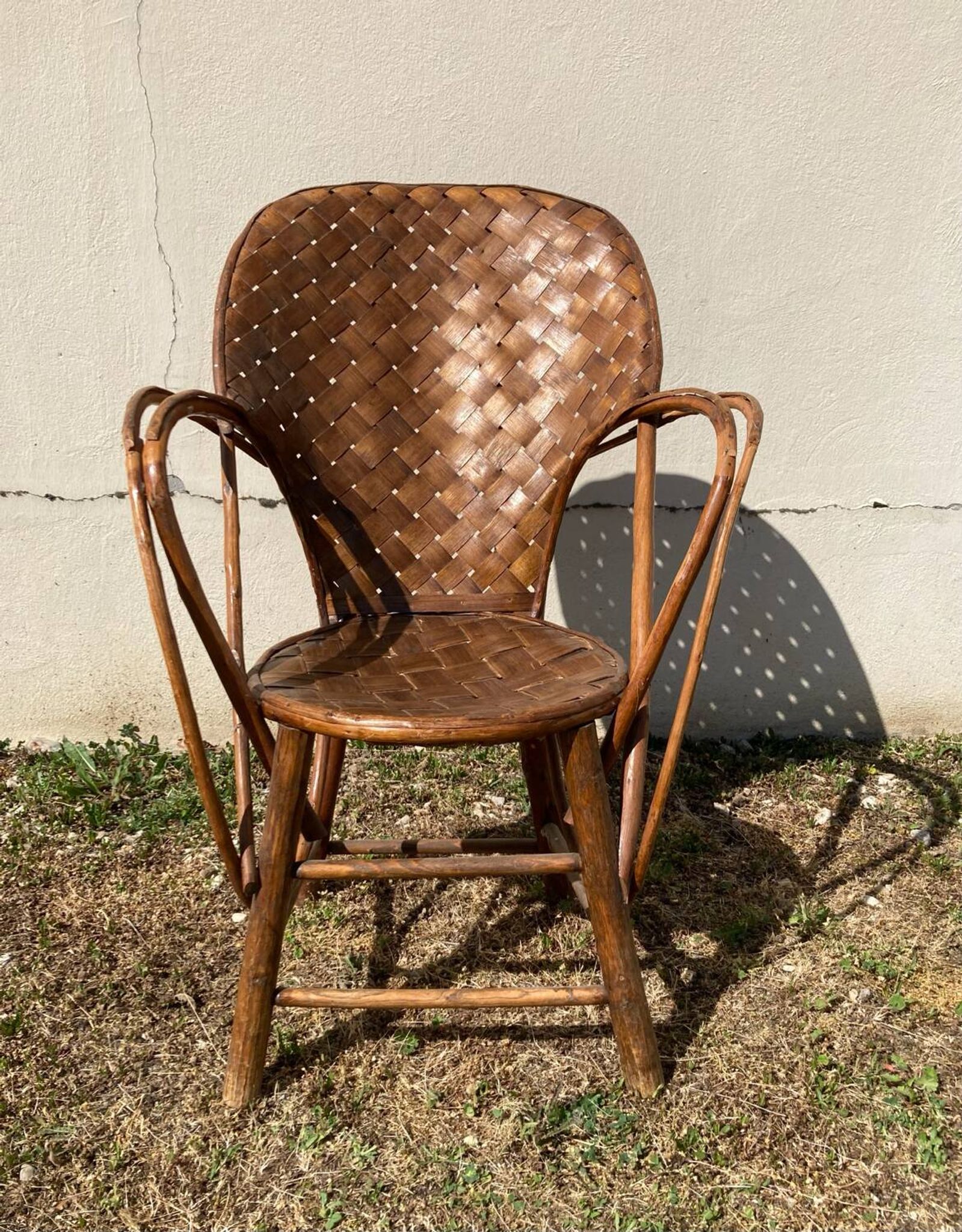 Vintage 1970s armchair in curved woven chestnut + seat cushion
