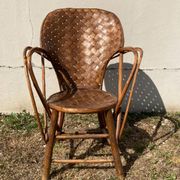 Vintage 1970s armchair in curved woven chestnut + seat cushion