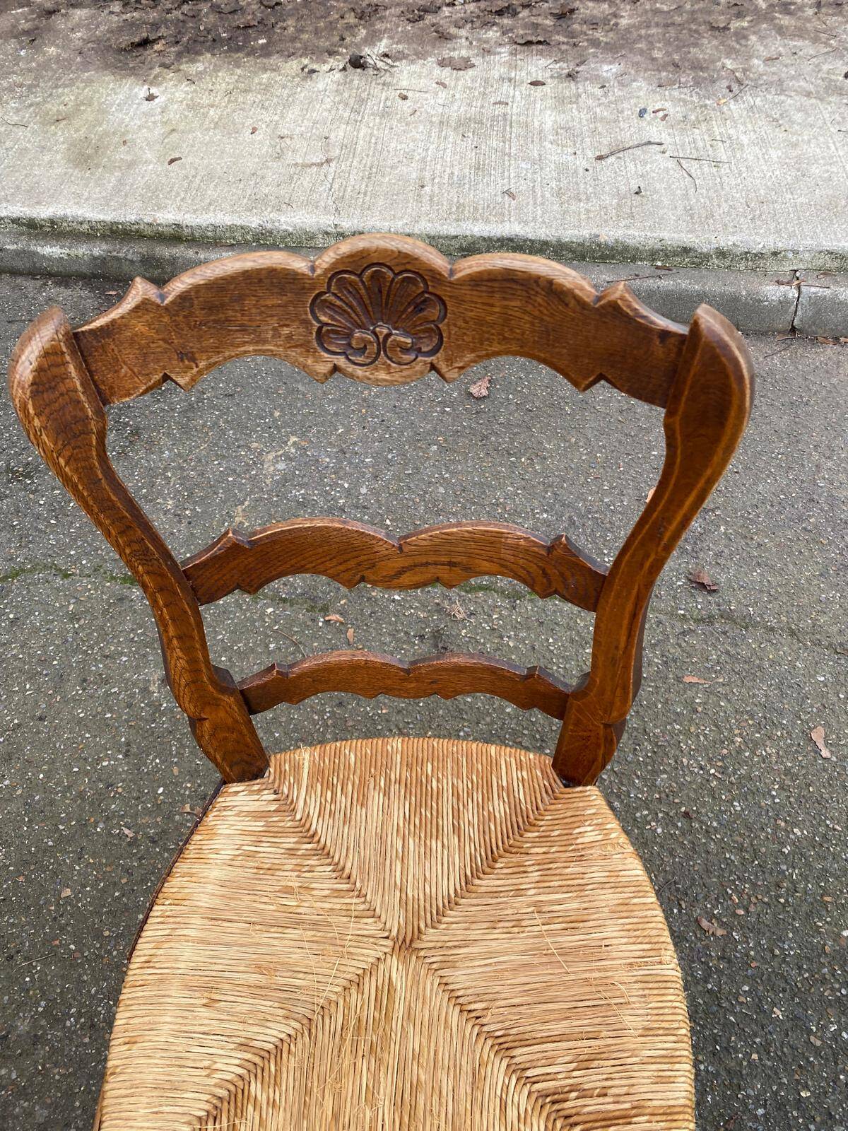 Louis XV 18th century solid wood dining chair with a straw seat.