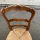Louis XV 18th century solid wood dining chair with a straw seat.