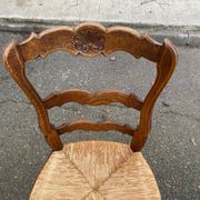 Louis XV 18th century solid wood dining chair with a straw seat.