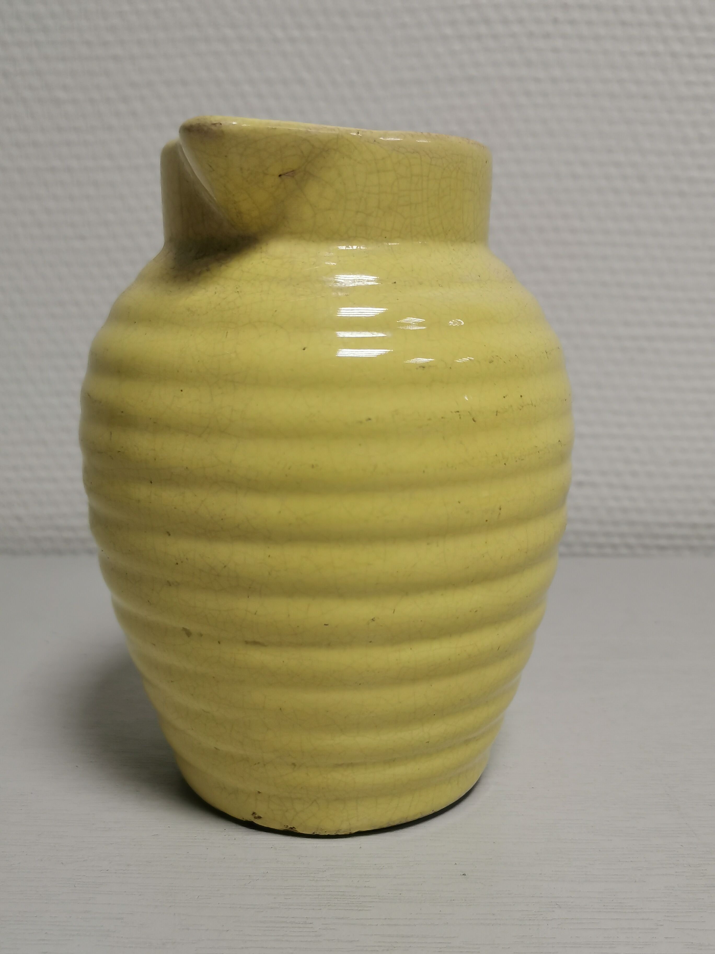 Yellow pitcher in slurry, faience onnaing frères