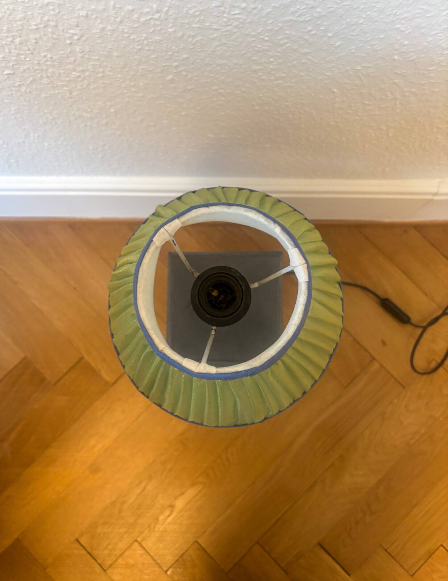 Vintage stone lamp with green pleated shade.