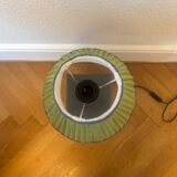 Vintage stone lamp with green pleated shade.