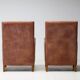 Pair of Art Deco armchairs in brown leather and teak, Netherlands, 1970s.