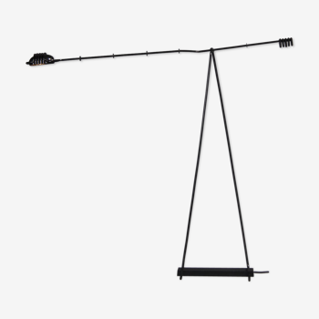 Floor lamp made from black painted metal with balancing arm