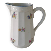 Earthenware milk jug with small flower patterns.