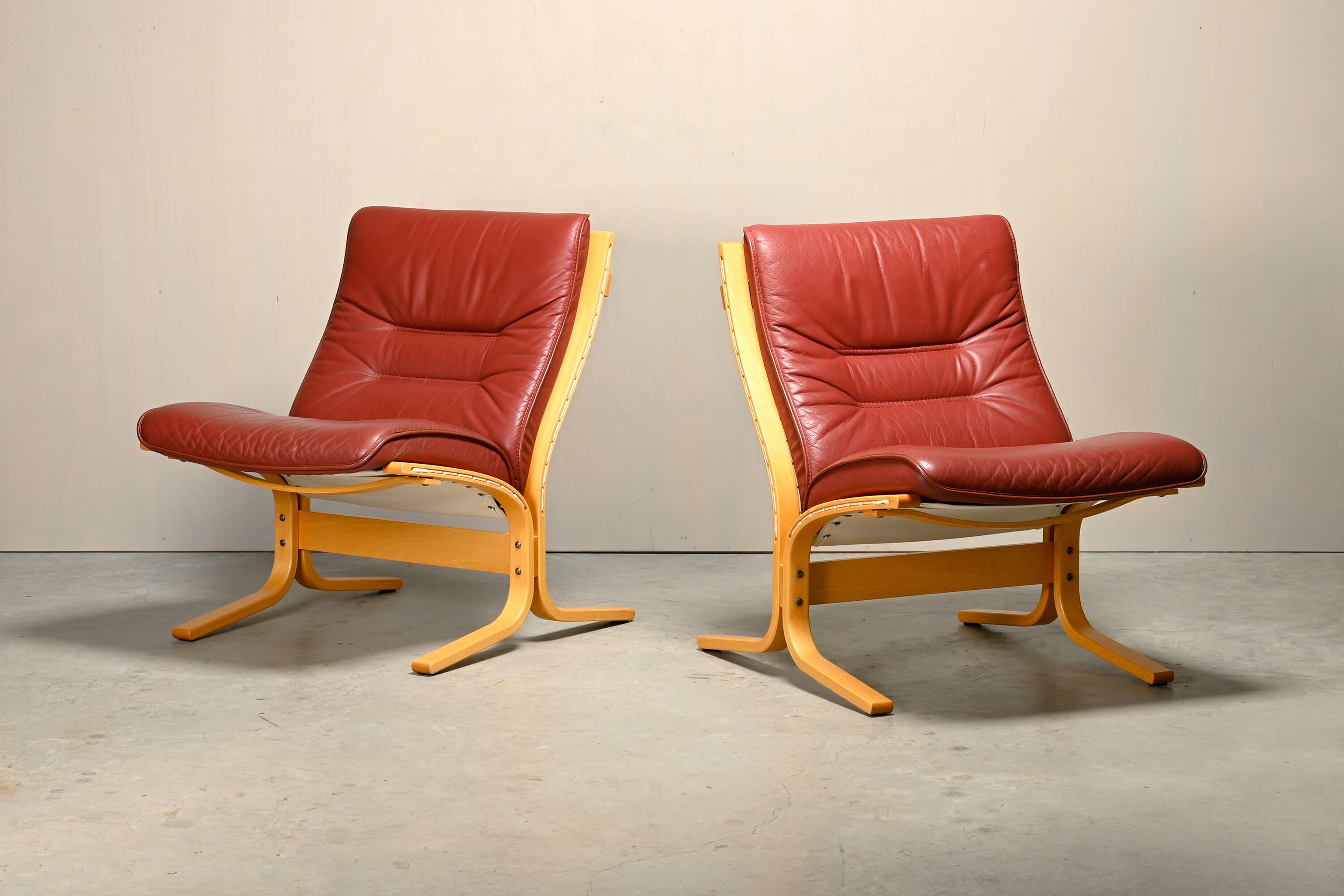 Pair Ingmar Relling Siesta Lounge Chairs in Beech and Burgundy Leather