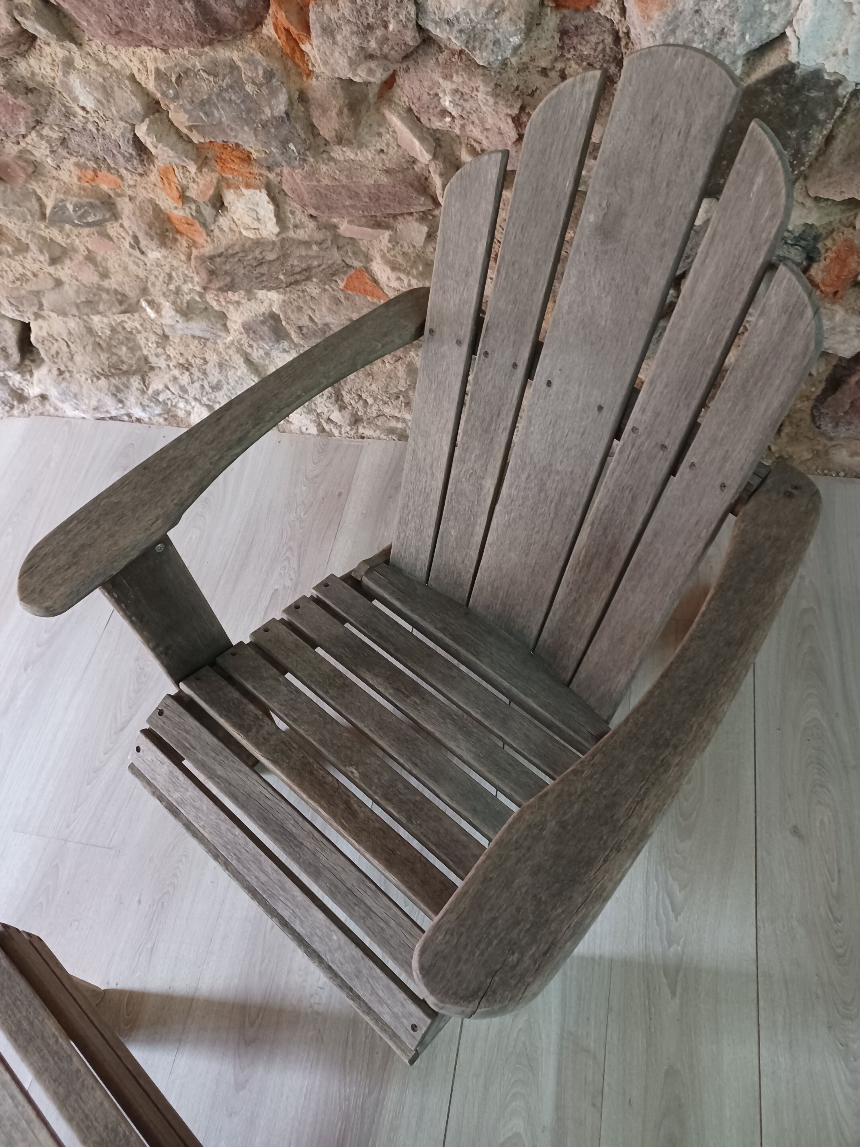Ancient Adirondack armchair with footrest