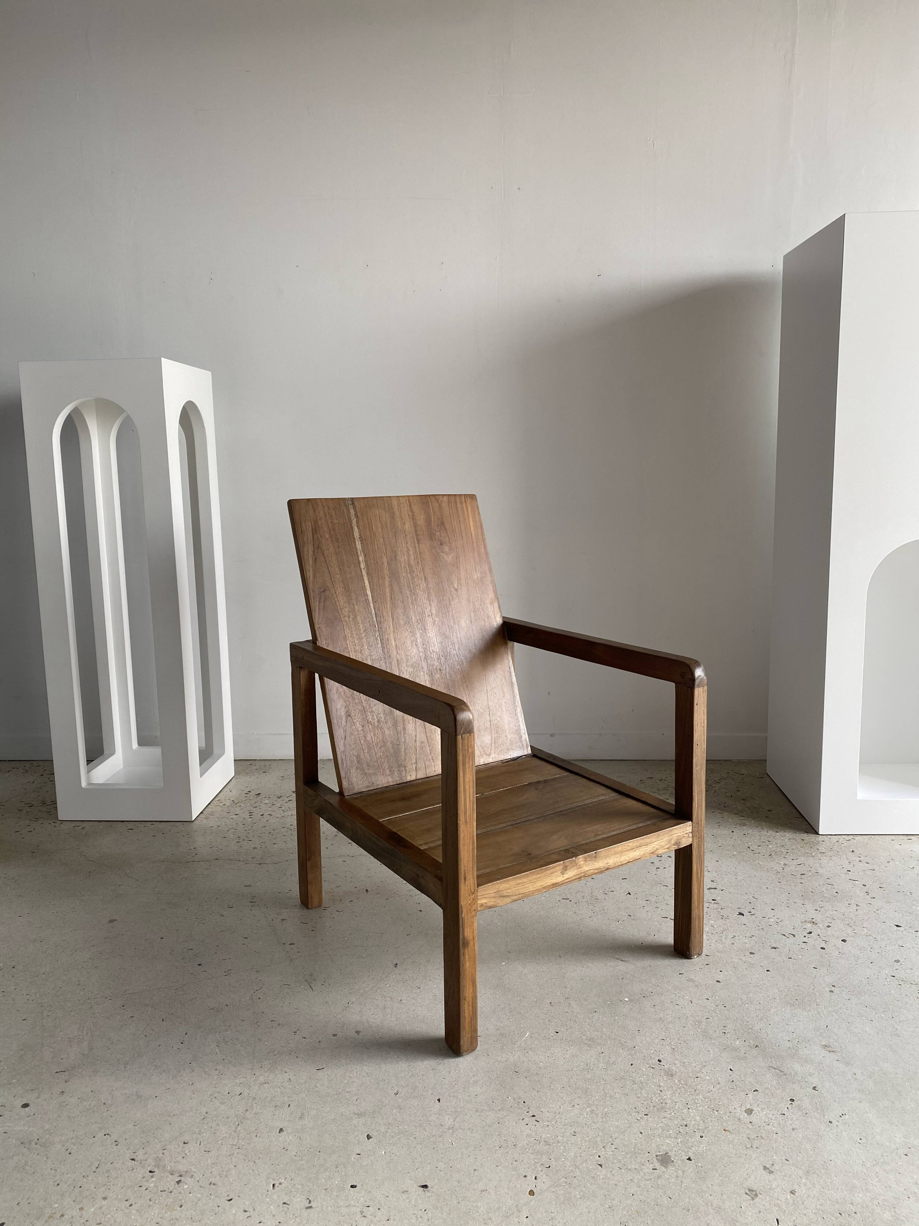 Large armchair in natural wood (teak) with a minimalist design.