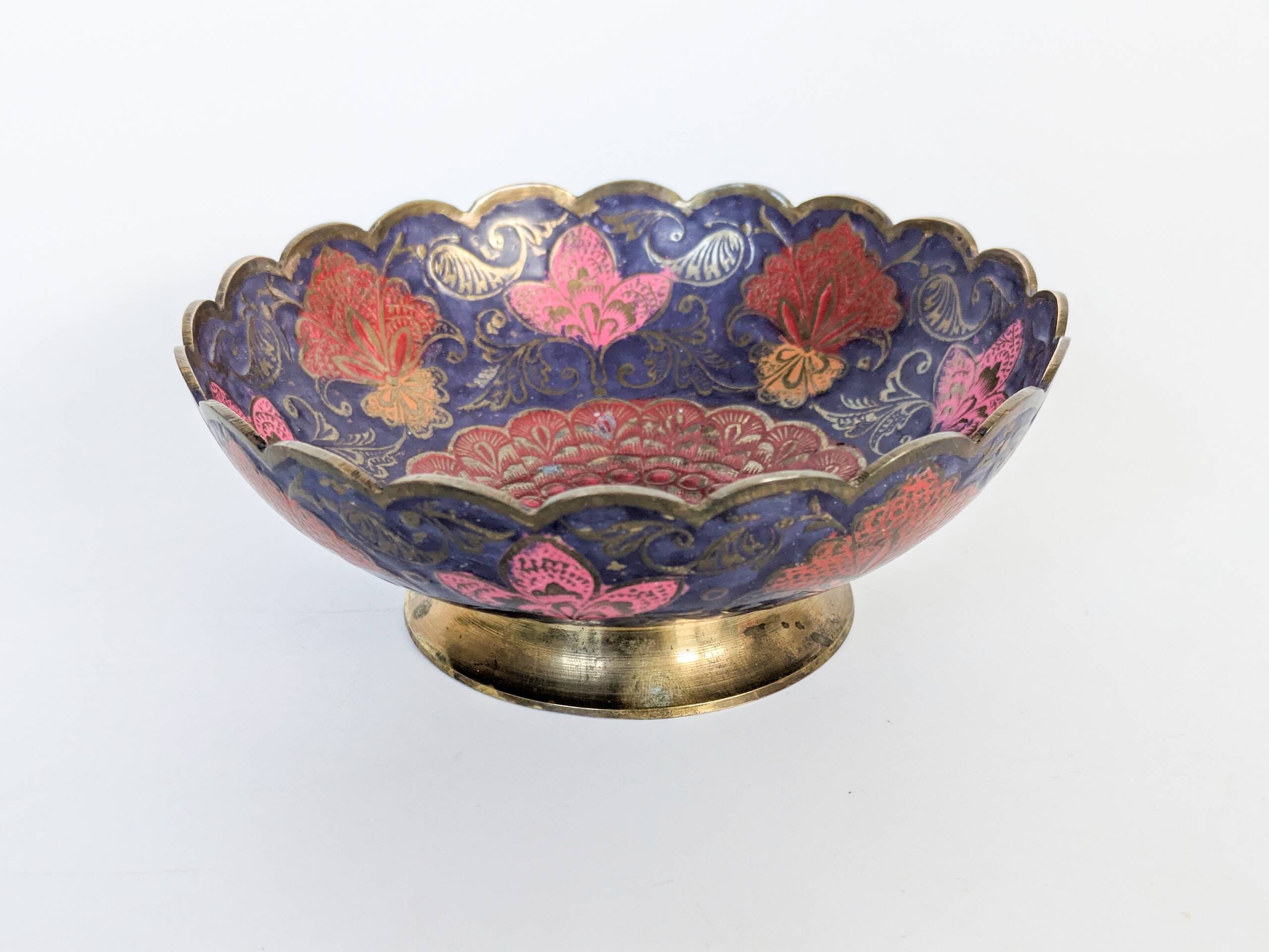 Vintage brass bowl with peacock motif, painted enamel, scalloped edge on a pedestal.