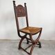 Pair of Neo-Renaissance oak chairs with straw seats, 1910