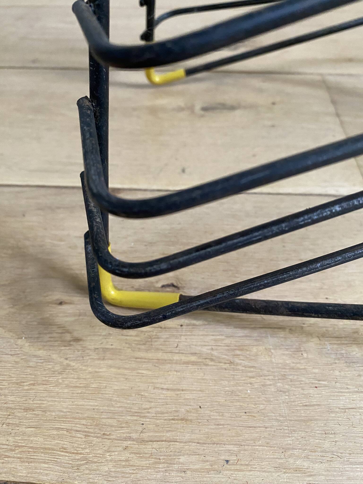 Black metal vinyl record holder and yellow scoubidou from the 60s