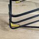 Black metal vinyl record holder and yellow scoubidou from the 60s