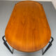 Solid wood dining table with tubular legs, 1980s postmodern design.