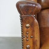 Characteristic antique sheepskin leather armchair with beautiful details and a unique design