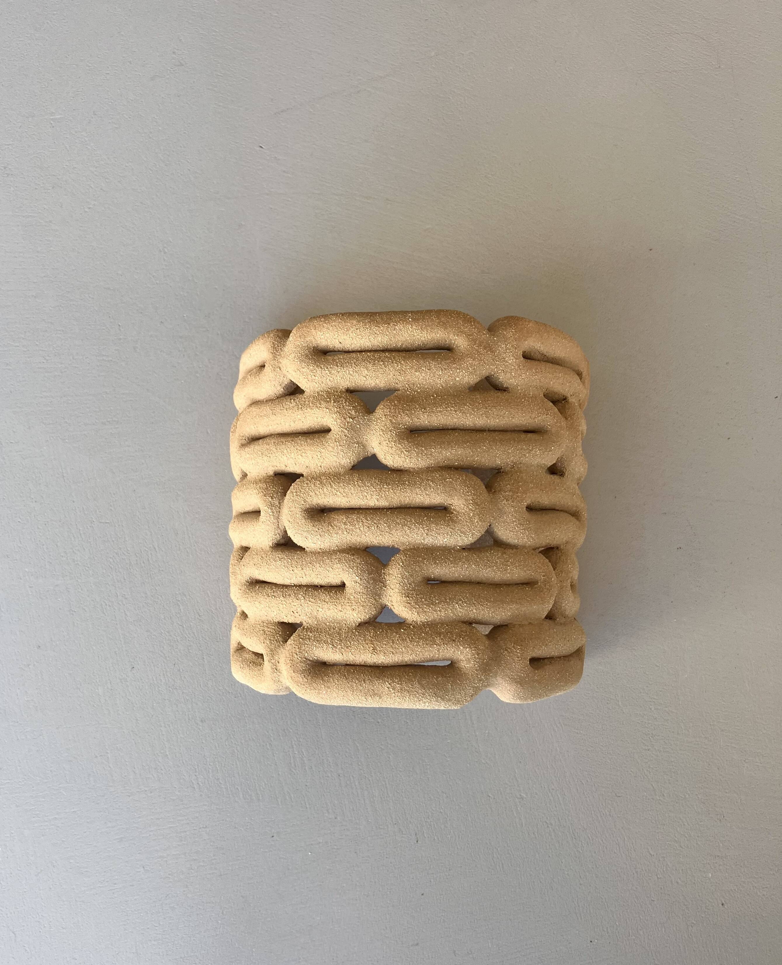 Handcrafted ceramic wall light in raw stoneware inspired by Mid Century design.