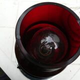 Red glass table lamp on a chrome base.