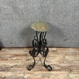 Wrought iron candlestick on four-legged base circa 1900-1930