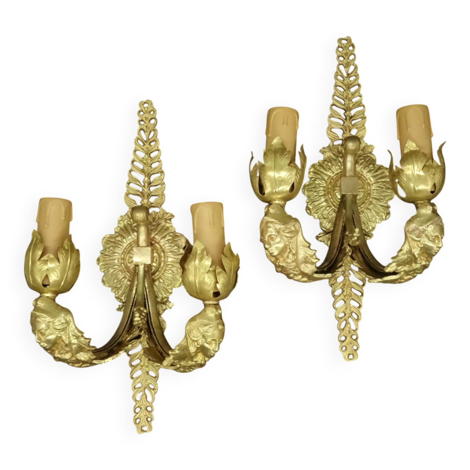 Pair of wall sconces with mask motifs in Empire style from the early 1900s - gilded bronze.