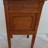 Antique bedside table with its marble top and white earthenware interior