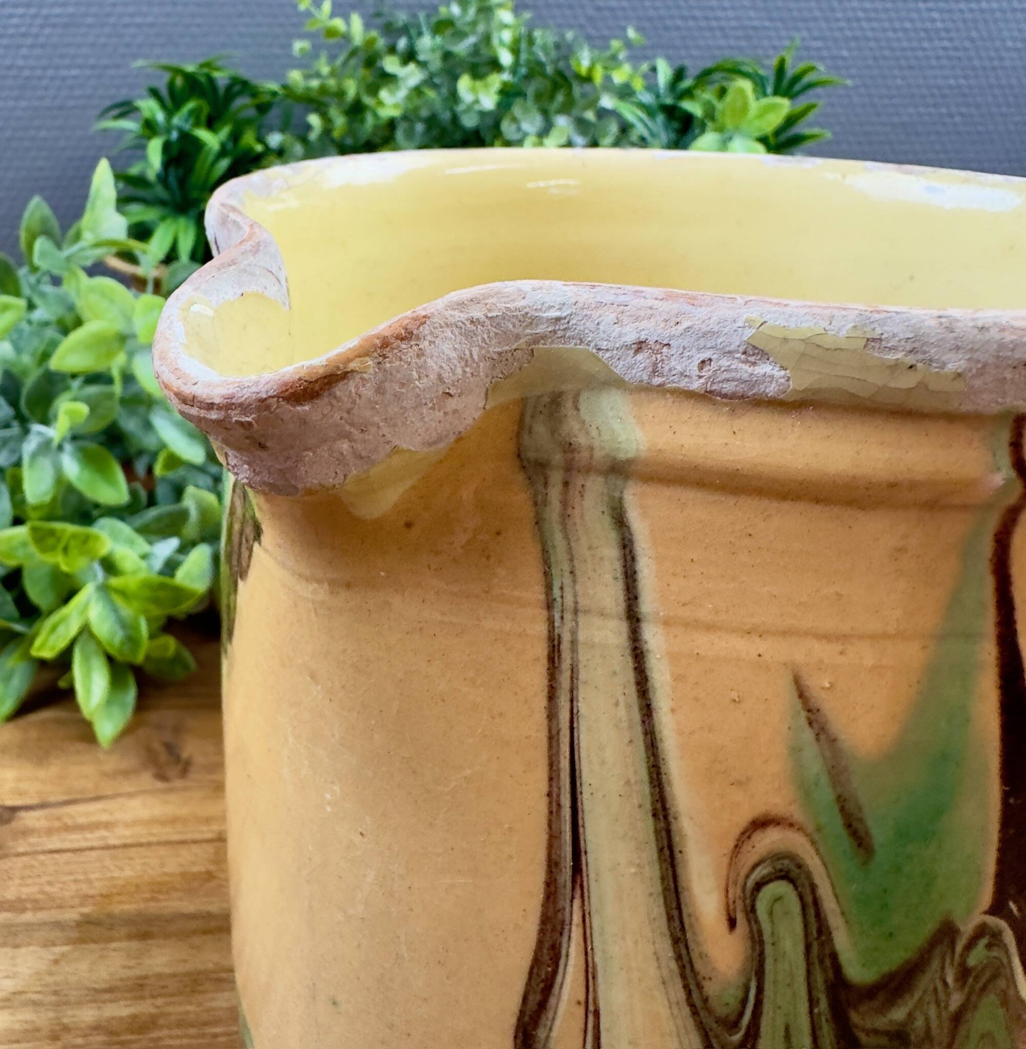 Large vintage ceramic pitcher with abstract green and brown decoration.