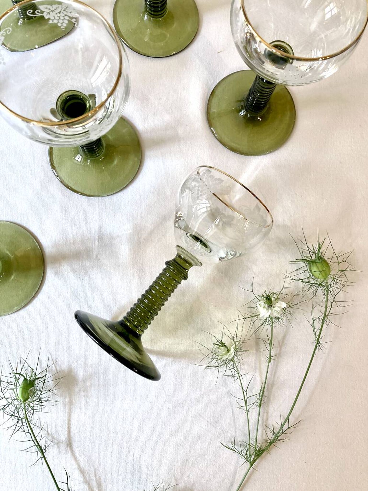 7 Alsace Roemer wine glasses, moss green stepped bases and gold trim.