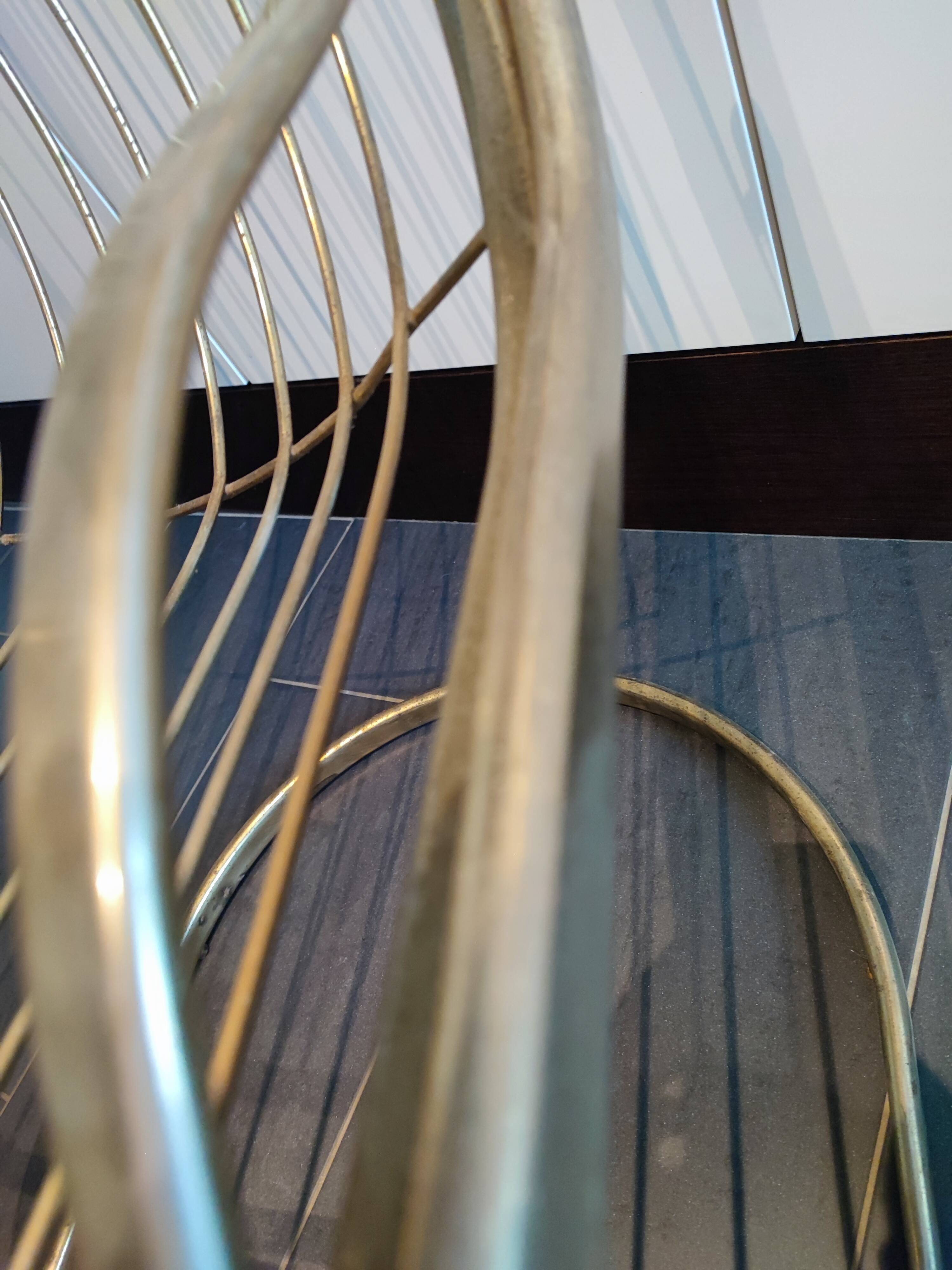 Tubular metal chair covered with gilding