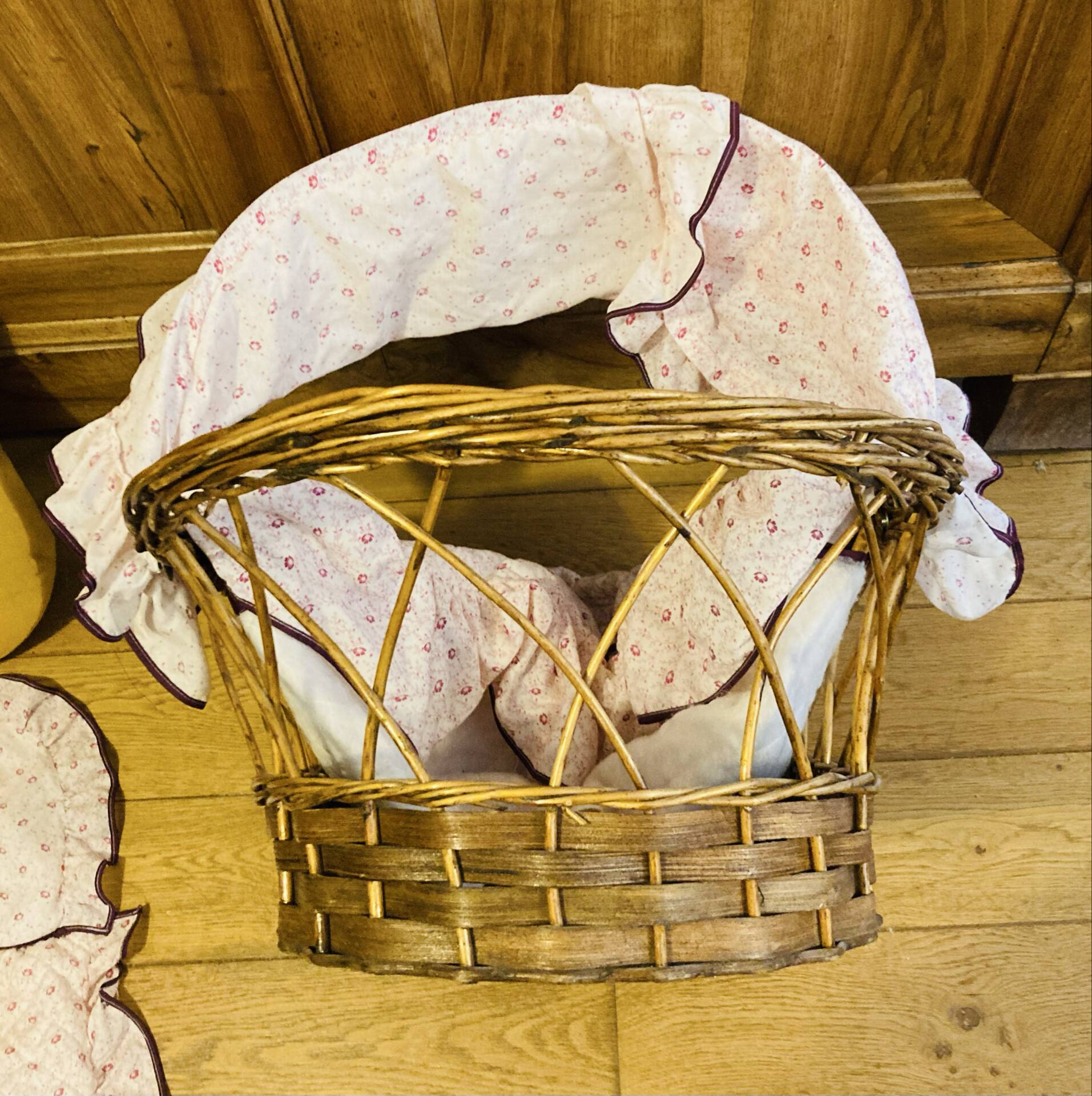 1960s wicker cradle with mattress and drapes.