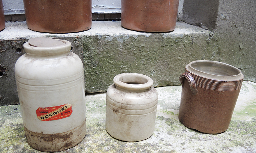 Collection of old sandstone pots with grease and mustard salting