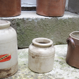 Collection of old sandstone pots with grease and mustard salting