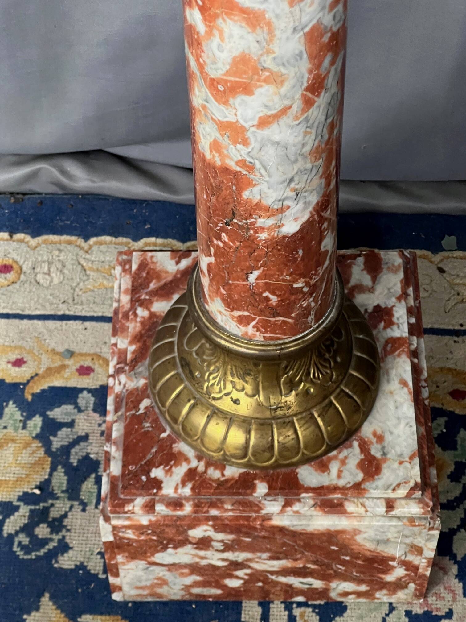 Marble pedestal decorated with gilded brass.