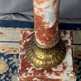 Marble pedestal decorated with gilded brass.