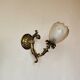 Bronze wall light with opaque glass tulip