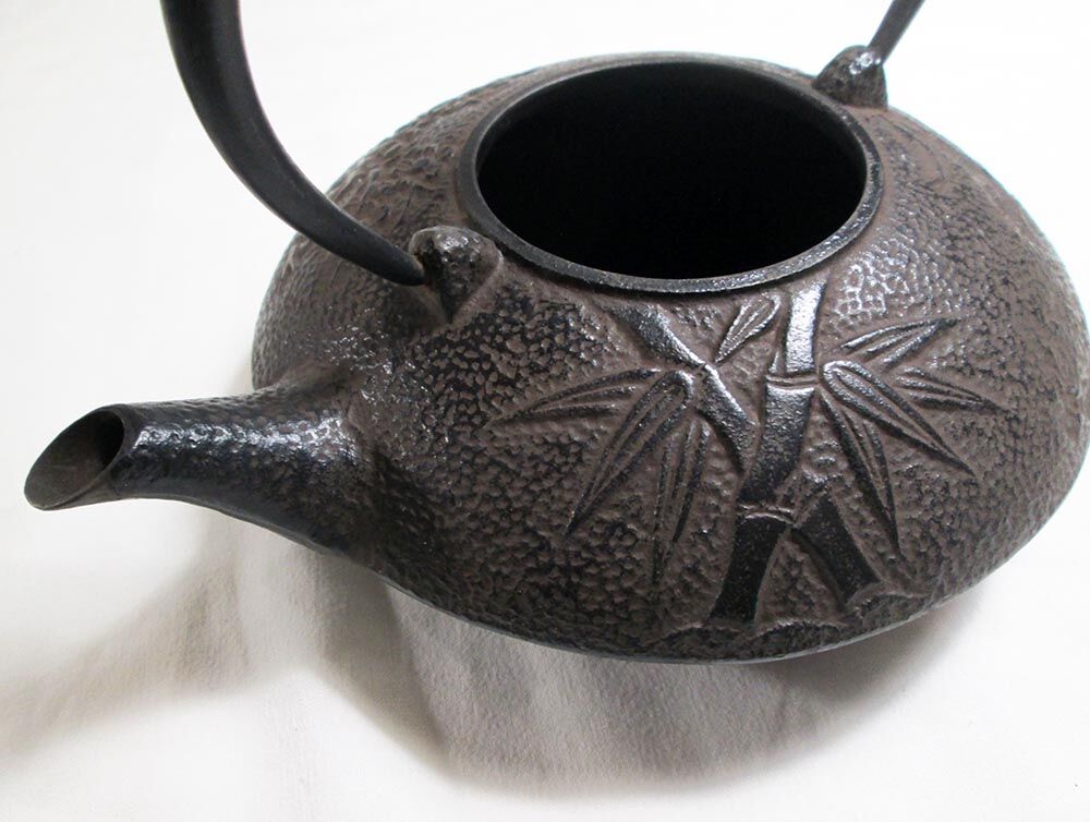Antique cast iron teapot decorated