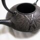 Antique cast iron teapot decorated