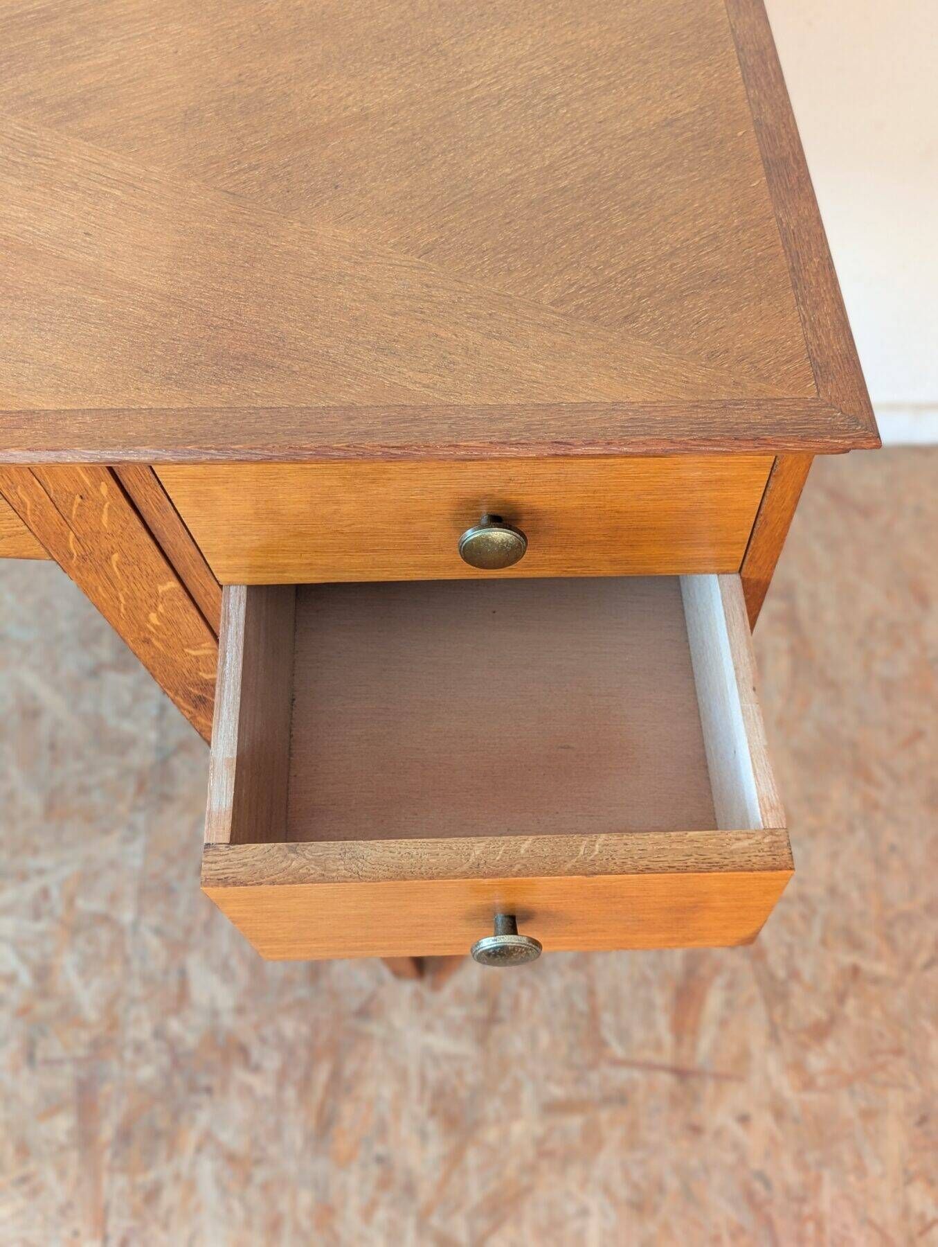 1950s oak double-sided desk with compass legs.