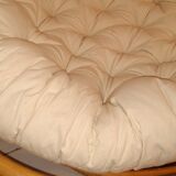 Rattan swivel chair and linen cushion