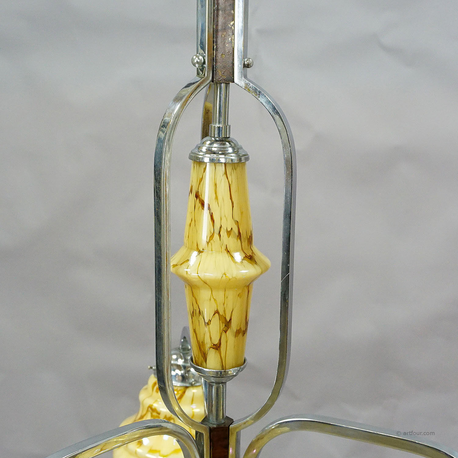 Antique Art Deco chandelier with three glass lampshades.