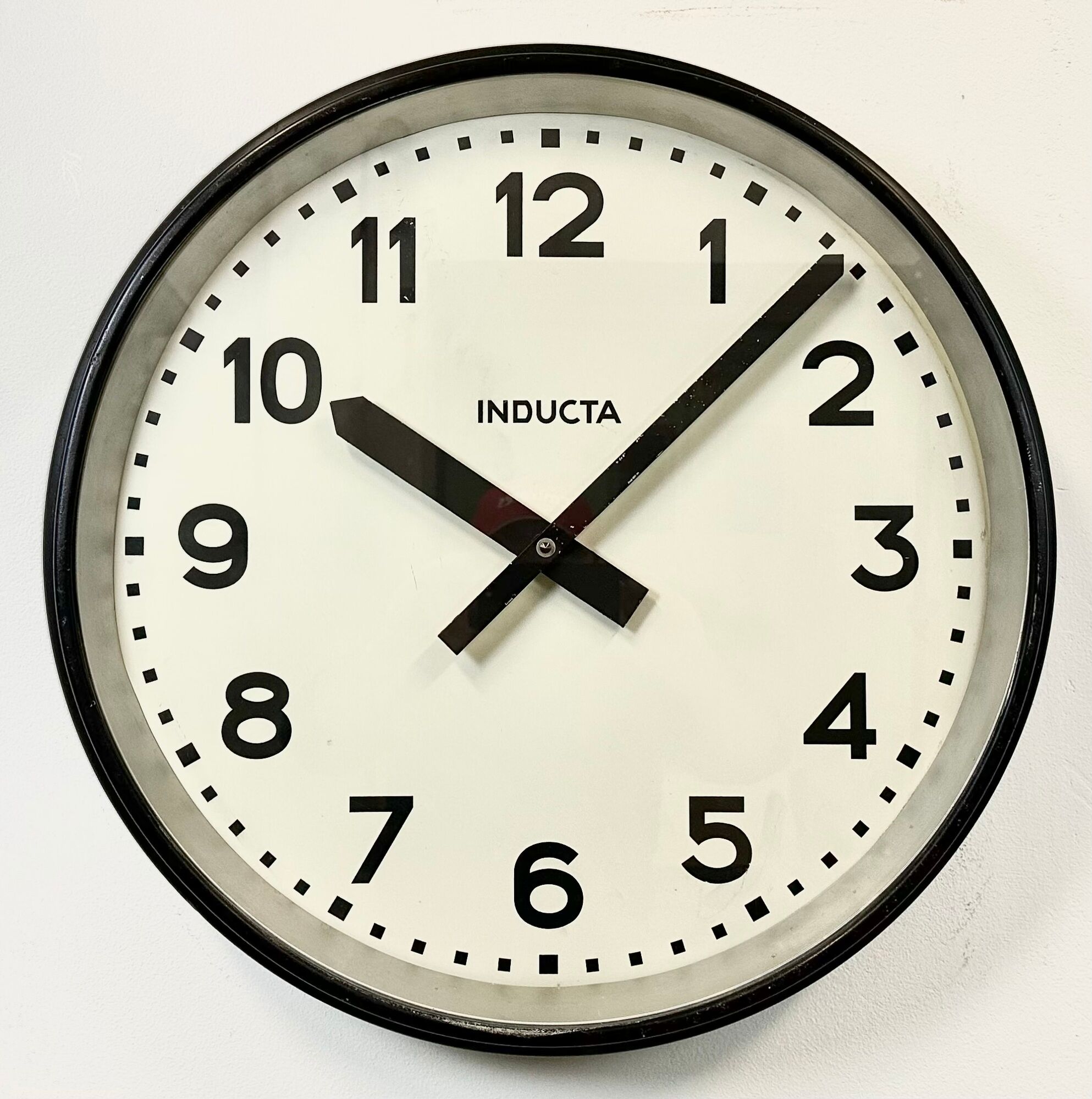 Black swiss industrial wall clock from inducta, 1960s