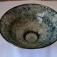 Bowl on a circular base or small blue ceramic dish.